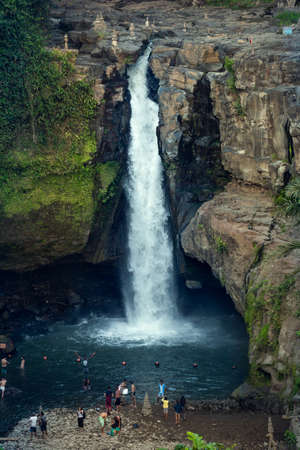 BALI, INDONESIA - October 19, 2018: Tourists swim in the Tegenungan waterfallのeditorial素材