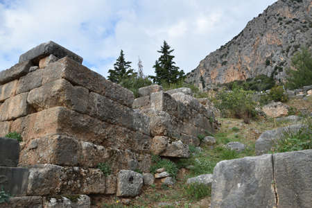 View of the main monuments of Greece. Ruins of Delphi, on Mount Parnassus. Oracle of Delphi. Old stone wall with inscriptionsの写真素材