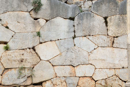 View of the main monuments of Greece. Ruins of Delphi. Ancient stone wall