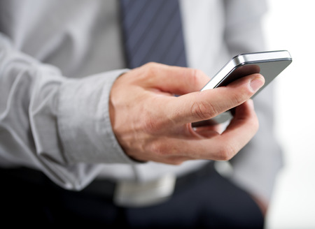 Closeup of a business man using mobile smart phone