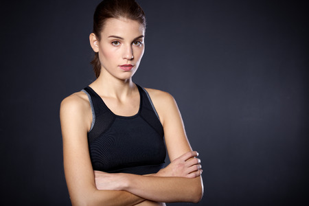 Portrait beautiful young athletic girl on a black backgroundの写真素材