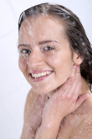 a beautiful woman standing at the showerの写真素材