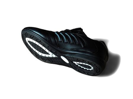 One black sneakers on a white backgroundの写真素材