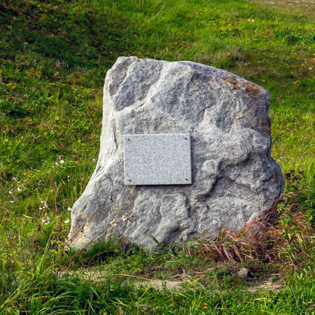 Memorial stone in the grass with a signの写真素材
