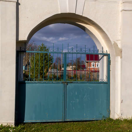 a gate in a white stone wall