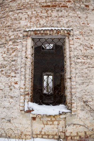 The window of a ruined temple with bars, Church of the assumption of the churchyard Czudec, Galichsky district, Kostroma province, Russiaの写真素材