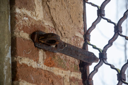 antique rusty padlock bracket on a brick wallの写真素材