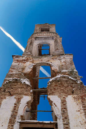 ancient brick bell tower against the skyの写真素材