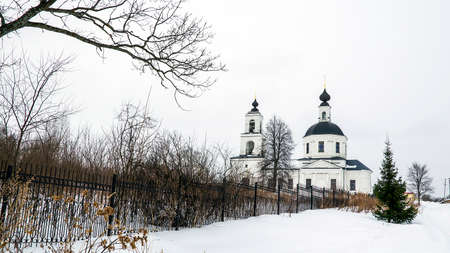 landscape with a rural Orthodox church in winter, Sungurovo village, Kostroma region, Russiaの写真素材