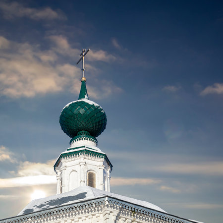 the spire of the Orthodox chapel with a cross on the sky backgroundのeditorial素材