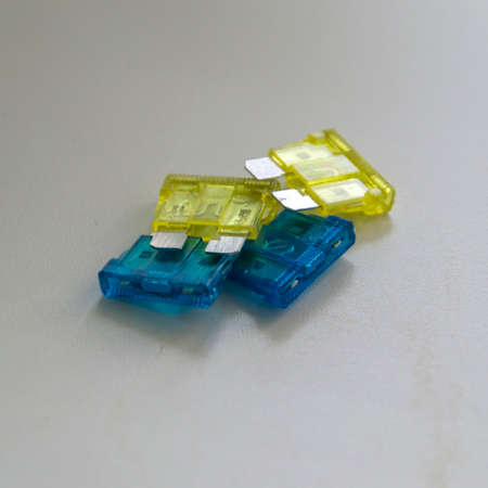 colored car fuses on a white background