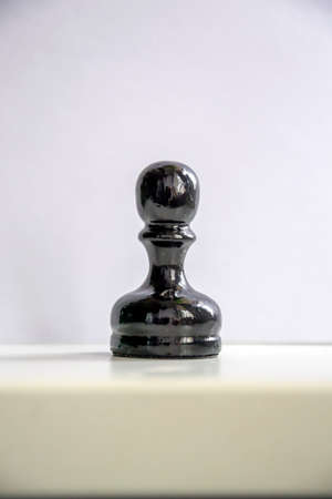 a lone chess piece on a white backgroundの写真素材