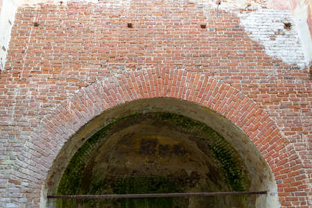 an old red brick arch in an abandoned churchの写真素材