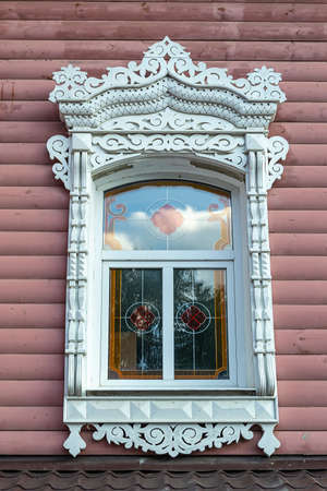 an old window with carved platbandsの写真素材