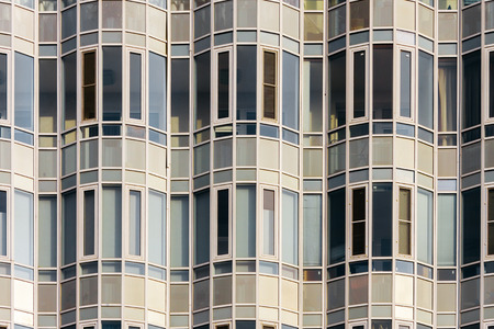 Facade of a modern building consists of glass, windows and lines