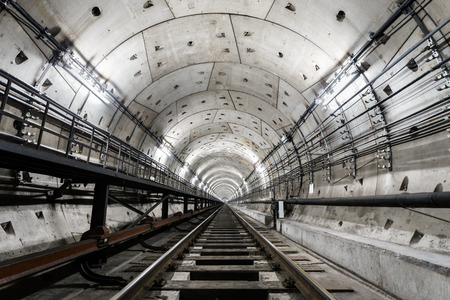 straight circular subway tunnel with a white lighting.の写真素材