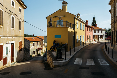 One road goes up, the other down. Crossroads in an old European city Vrsar, Croatia.の写真素材