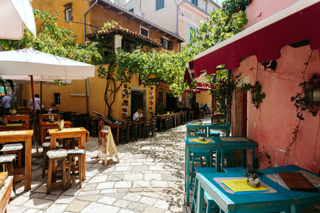 Porec, Croatia - July, 2016 - Empty tables of European cafe on a street in the historic center of Porec, Croatiaのeditorial素材