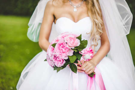 Bride holding wedding bouquet on wedding ceremonyの写真素材