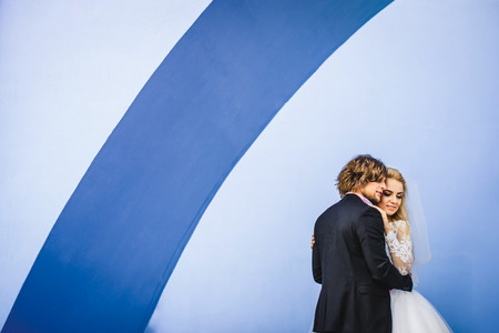 Elegant bride and groom posing together outdoors on a wedding dayの写真素材