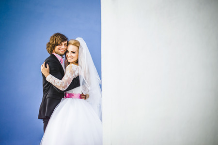 Elegant bride and groom posing together outdoors on a wedding dayの写真素材