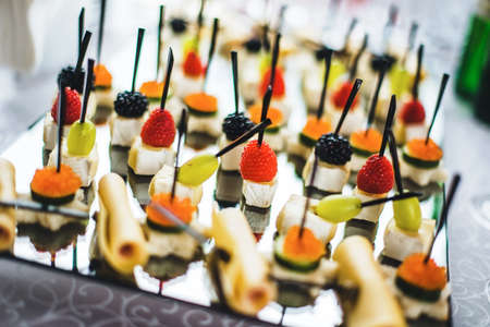 white marshmallows with ripe red raspberries, blackberries and grapeの写真素材