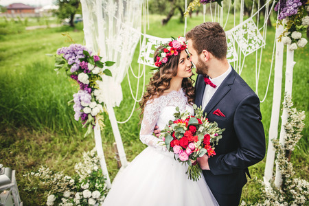 bride and groom outdoors. wedding ceremony. wedding arch.の写真素材