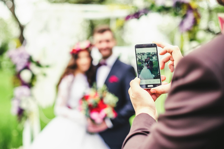 bride and groom outdoors. wedding ceremony. wedding arch.の写真素材