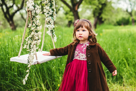 portrait of a beautiful little girl near the swingの写真素材