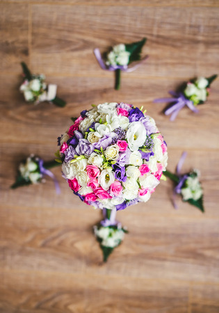 Bridal bouquet and buttonhole on the wooden tableの写真素材