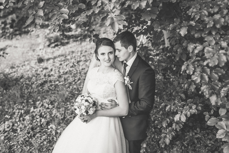 Wedding. Portrait of bride and groom on the forest at wedding day. Empty space. Wedding conceptの写真素材