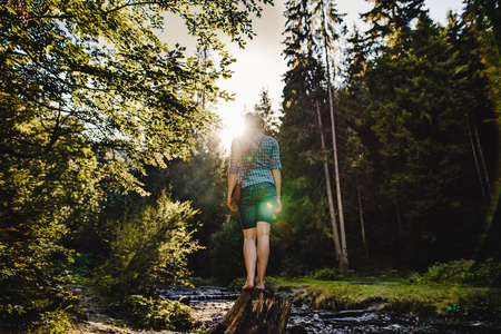 a girl in a forest under the sunlightの写真素材