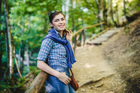 Tourist girl walking in the wood, forestの写真素材