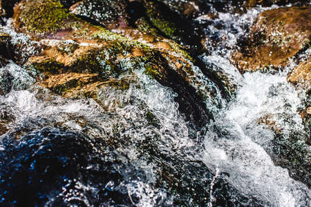 Waterfall close up. Water cascade on moss stonesの写真素材