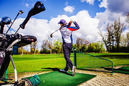 golfplayer hits a ball on the grassの写真素材
