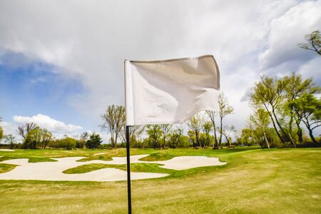 white Golf Flag Waving on a golf fieldの写真素材