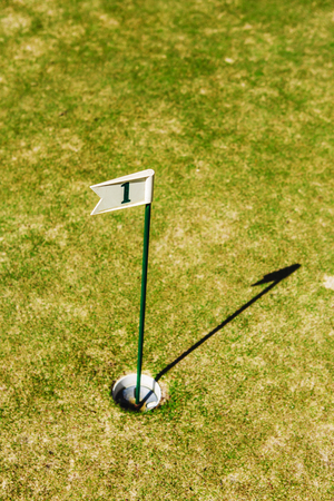 close up of flag mark in hole on golf field.の写真素材