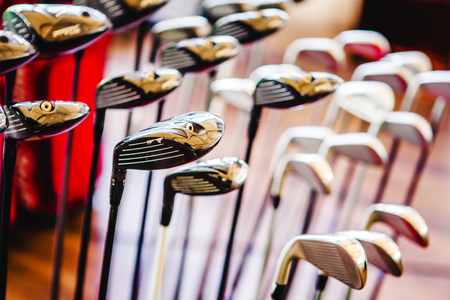 A shiny metal golf clubs for sale show in shop rack.の写真素材