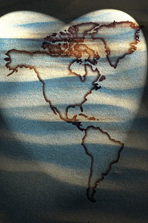 North and south America continents map on sand 