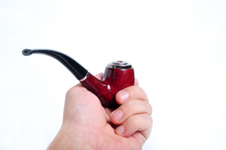 A hand holding a pipe on white background