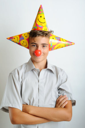 Young boy with party horn and clown nosesの写真素材