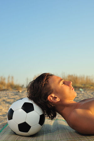 Young boy sunbuthing on beach, close upの写真素材