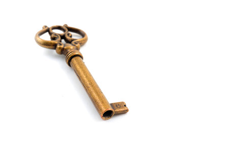 Simple old style key on white, close upの写真素材