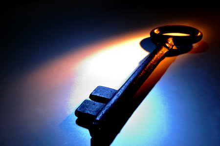 Close up of an old key in colorful lightの写真素材