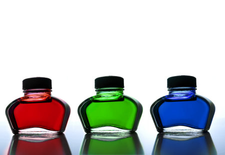 Three bootles with primary colours ink, red green and blueの写真素材