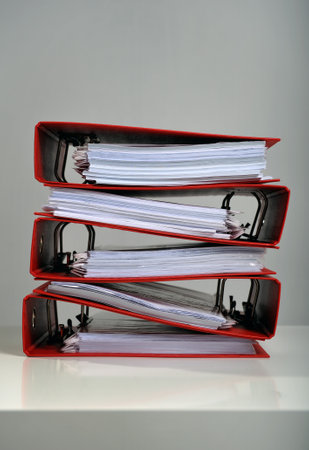 Stack of red folders on desk, deadline conceptの写真素材