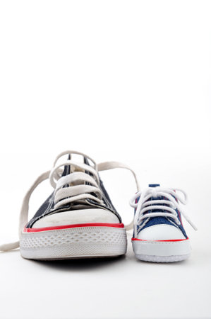 Father ans son sport shoes on white backgroundの写真素材