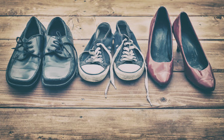 Different shoes on a wooden tableの写真素材
