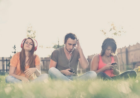 Boy and girl  listening to music on headphonesの写真素材