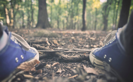 Man in sneakers in the forest